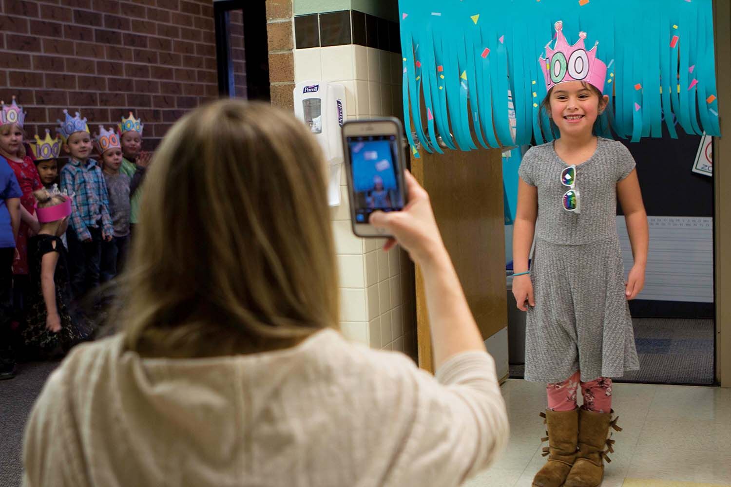 Kindergartener Mercedes Rios poses for a celebratory 100th Day of School photograph